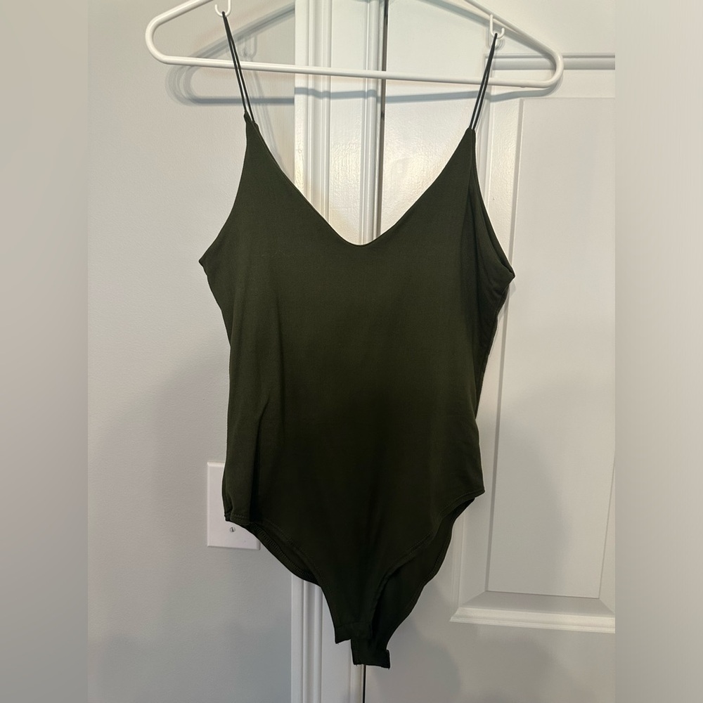 Pack of 3 Solid Colored Body Suits with snap bottom.